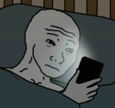 The 'Wojak' meme depicts a sad, bald cartoon character lying in bed in the dark, illuminated only by a smartphone screen.