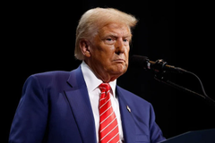 Donald Trump, wearing a blue suit and red tie, is shown in a close-up headshot looking sternly forward. The image likely serves as a visual representation to draw attention or evoke a particular sentiment related to the accompanying text discussing financial markets and potential "wipeouts."