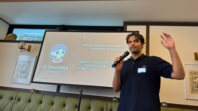 A man named DevenMat, Co-founder and CEO, presents at a Tokyo event, with a slide announcing "@ Valantis is building new trading and experience on Hyperliquid" alongside his anime-style avatar. The presentation ties directly to the post, which thanks attendees for joining the trader event in Tokyo where special codes were distributed to early depositors through the Hyperliquid Japan Community.