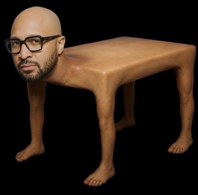 A surreal image of a human-like wooden table with the head of a bald man with glasses and a beard on one end and human-like legs/feet at the corners, against a black background.