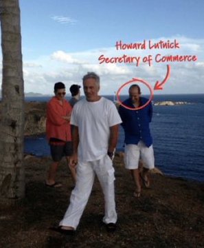 The image shows three men standing on a cliff overlooking the ocean, with one man circled and labeled "Howard Lutnick - Secretary of Commerce" in handwritten red text. A palm tree is visible on the left, suggesting a tropical or coastal vacation setting. This connects to the post's conspiracy theory by visually identifying Lutnick as the alleged coordinator of the "Warsh and Bessent" financial scheme to "cash in on a deflationary event," implying a covert meeting or planning session at this scenic location.