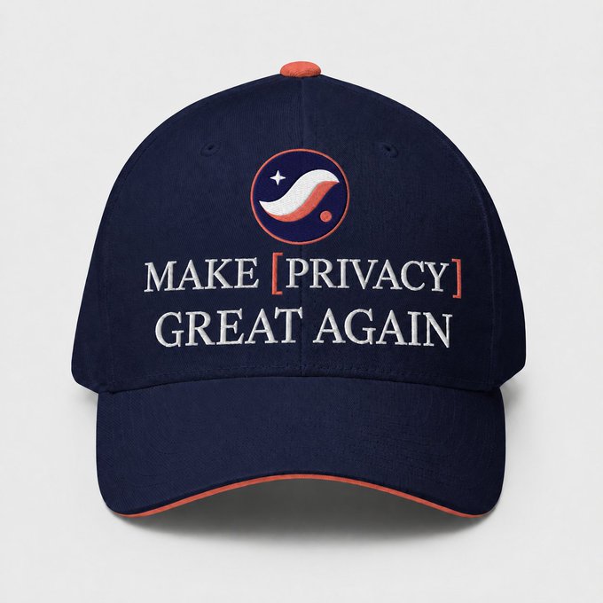 A navy blue baseball cap with orange accents displays the text "MAKE [PRIVACY] GREAT AGAIN" embroidered in white below a small logo featuring a mustache and star inside an orange circle, aligning with the post's message of championing privacy on the Starknet platform.