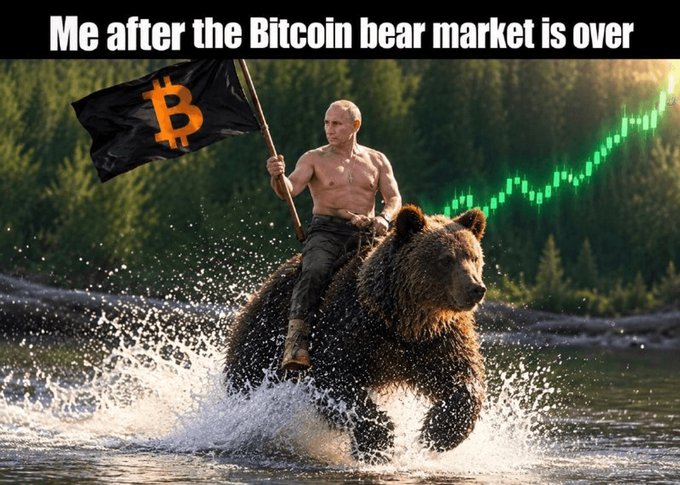 A meme with text 'Me after the Bitcoin bear market is over,' showing Vladimir Putin riding a bear through water while holding a Bitcoin flag, with a green price chart in the background.