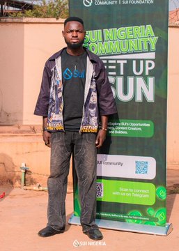 Blessedfingers poses in front of a "Sui Nigeria Community" banner at what appears to be a Sui Network meetup, aligning with the post's caption about co-hosting the first Sui event in his town and attending six or more SuiNetwork events. The banner promotes "Get Up Fun" and "Explore Web3 Opportunities."