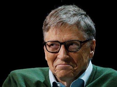 A portrait of Bill Gates shows him wearing glasses and a green sweater, with a notable frown expression.