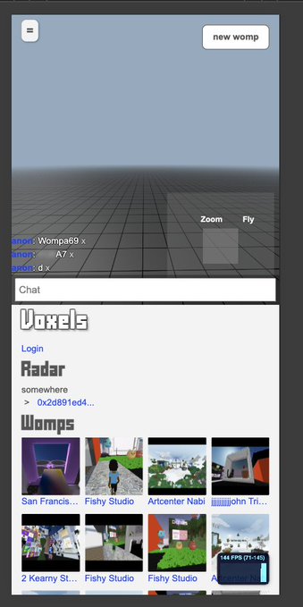 A screenshot of the Voxels platform showing a 3D environment with chat options ('Zoom', 'Fly') and a grid of virtual world thumbnails labeled 'Womps' including 'San Francis...', 'Fishy Studio', and 'Artcenter Nabil'.
