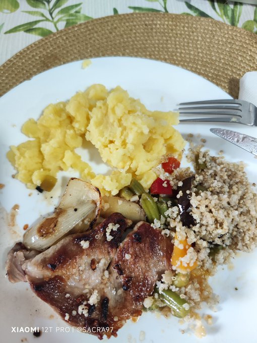 The image shows a plate of food consisting of meat, rice, and vegetables such as potatoes and carrots. A fork is placed next to the plate, ready for use. The photo has been tagged with the hashtag #hive, which could be related to the content or context of the meal being served.