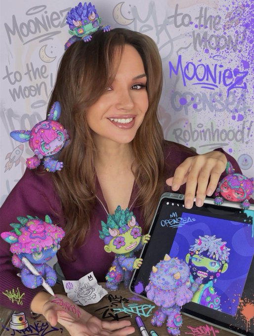 A promotional image for 'MOONIEZ' by Mr. Opensea, showing a woman surrounded by colorful purple and green cartoon character figurines, with a tablet displaying artwork and text reading 'to the Moon!' and 'Robinhood!'.