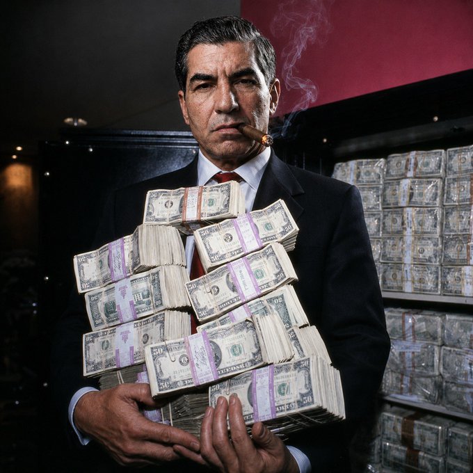 A man in a suit holds a large stack of $50 bills while smoking a cigar, with additional bundles of cash stacked behind him. The image evokes the "gains" mentality of bullish market sentiment—ironically contrasting with the post's message that trend direction, not traditional support and resistance levels, is what truly matters in trading.