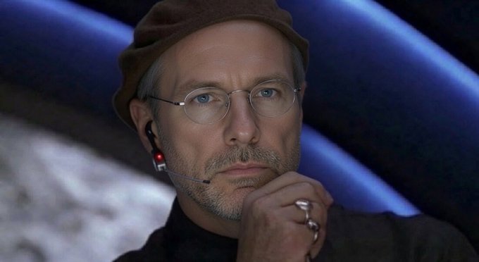 A man with glasses and a brown cap wearing an earpiece rests his chin on his hand, appearing deep in thought. The image humorously captures the contradiction in the post's message about Bitcoin—telling others to hold while planning to sell—reflecting the conflicted expression of someone caught in that very dilemma.