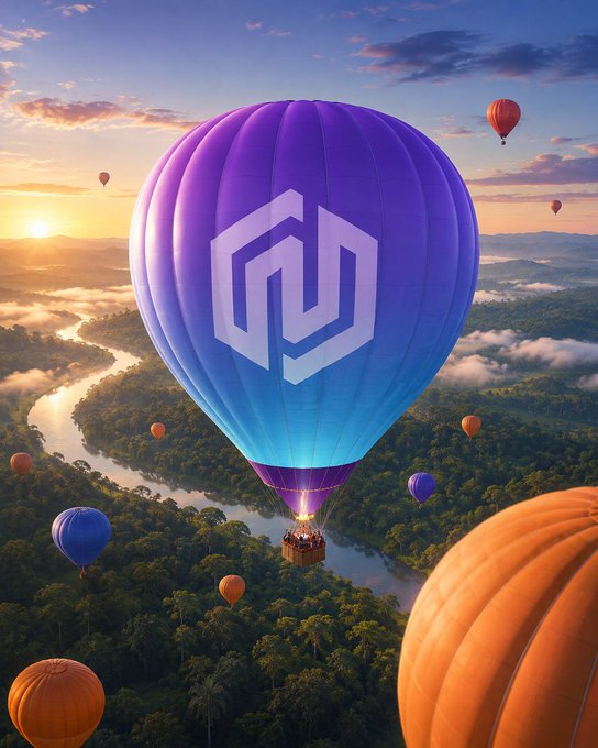 A vibrant purple and blue hot air balloon featuring a stylized "M" logo soars above a lush, mist-covered landscape at sunrise, surrounded by other colorful balloons drifting over forests and rivers. The image's elevated, sky-bound perspective and "rising to new heights" theme perfectly matches the celebratory "GM!" (Good Morning) message, evoking a sense of optimism and upward momentum.
