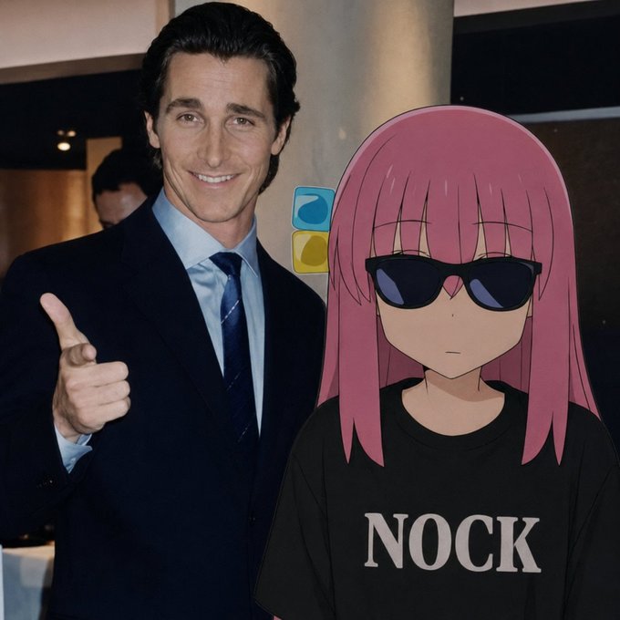 A man in a dark suit giving a thumbs-up stands next to an anime character with pink hair, sunglasses, and a black shirt with 'NOCK' printed on it.