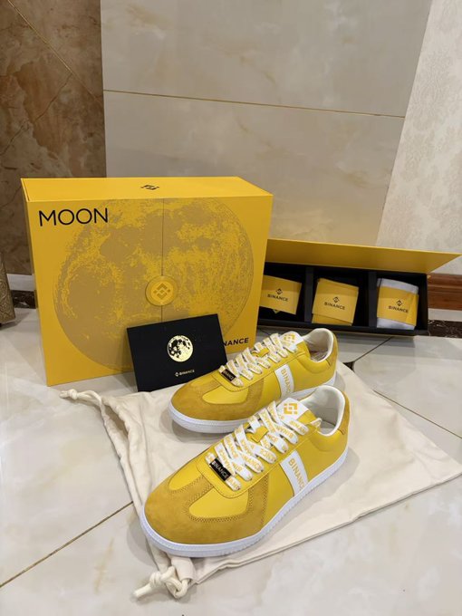 Yellow Bitvance 'MOON' branded sneakers displayed with their packaging box featuring a moon design.