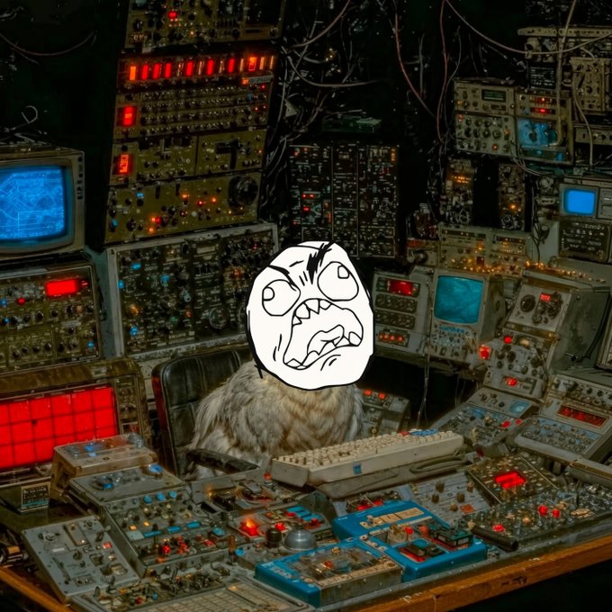 A fluffy cat sits at a desk filled with vintage electronic equipment, but its head is replaced by a black-and-white 'rage face' meme drawing.