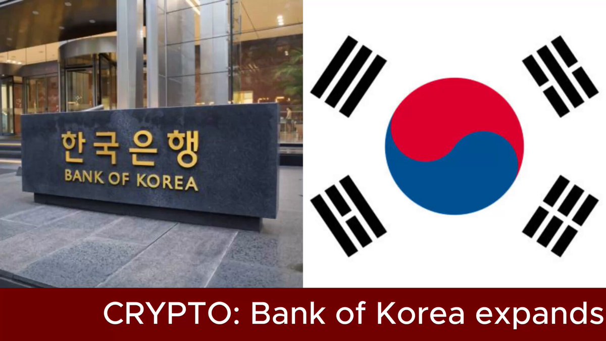 The image features a black sign with gold lettering that says "CRYPTO: Bank of Korea expands" written in Korean. The background of the image shows a building, which could be a bank or some other financial institution. There is also an image of the Korean flag displayed on the side of the building.