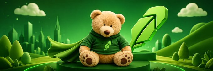 A 3D-rendered teddy bear wearing a green hoodie with a leaf logo sits on a pedestal in a green landscape, accompanied by a large green arrow pointing upward.
