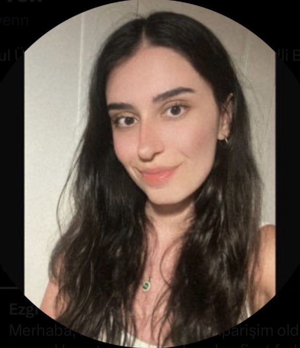 A young woman with long dark wavy hair smiles softly in a circular profile photo, wearing a small necklace and hoop earrings, with Turkish text visible in the background.