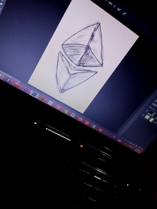 A pencil sketch of geometric crystalline shapes displayed on a laptop screen, with the Windows taskbar visible at the bottom.