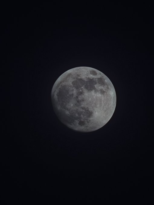 A clear, detailed photograph of a full moon against a dark black sky.