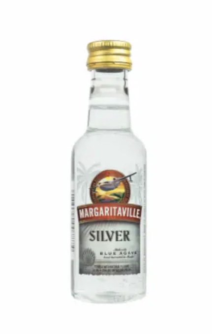 The image features a small glass bottle with a gold cap, containing a shot of silver liquor called "Maggartville Silver". The bottle has a label that reads "Maggartville Silver" and "Silver", indicating its brand name. The bottle is placed against a white background, making it the main focus of the image.