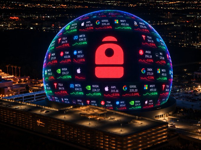 The Las Vegas MSG Sphere illuminated at night displaying a large red padlock symbol surrounded by a stock ticker showing various stocks including AAPL ($315.36), GOOGL ($335.20), MSFT ($493.50), META ($634.72), TSLA ($354.76), NVDA ($224.37), AVGO ($356.18), and INTC ($102.67).