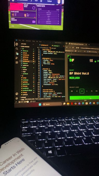 A laptop displaying coding software with a football match on a screen above it; a sign-up page for 'SF Shirt Vol.5' priced at ₦20,000 is visible, along with a book titled 'Career in Web Development Starts Here'.