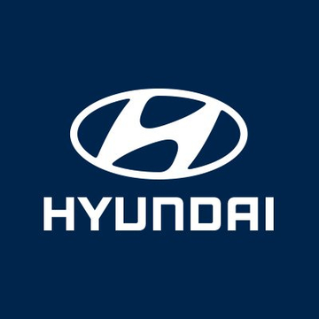 The image displays the Hyundai logo, featuring a stylized white "H" inside an oval above the "HYUNDAI" wordmark, set against a dark blue background. This branding relates to the post about Hyundai Card's exploration of Avalanche (AVAX) blockchain technology for expanding financial services beyond traditional banking hours.