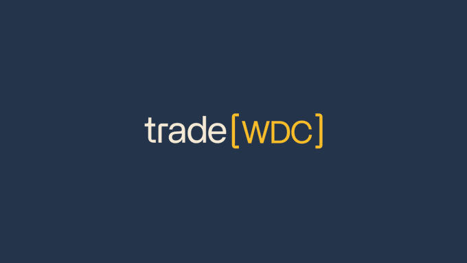 The image features a blue and white logo with a yellow "WDC" in bold letters that reads "Trade (WDC)". The background of the design has a gradient transition from dark blue at the top to lighter gray towards the bottom, giving an elegant appearance to the logo. In the corner, there is a small text that says "WDC is now live. 10x leverage, 24/7, 365." This information emphasizes the versatility and adaptability of the platform to users' needs.