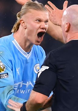 A Manchester City player, wearing a jersey featuring "Etihad Airways" and "No Room for Racism" logos, shouts intensely toward an official on the field. The image likely captures the tense atmosphere of a match, fitting the context of a high-stakes $140,000 Polymarket bet on City not winning against Manchester United.