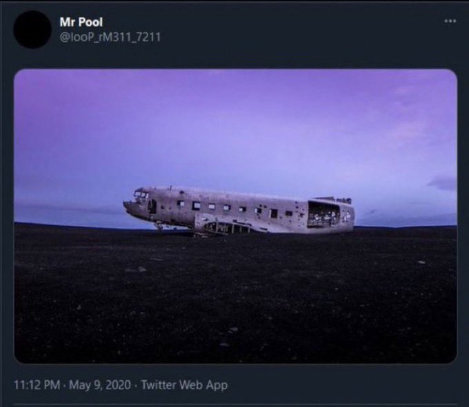 A tweet from "Mr Pool" (@loop_rM311_7211) dated May 9, 2020, showing the weathered wreckage of an abandoned airplane fuselage in a desolate black landscape under a purple sky. The caption references XRP and dates "5/9" and "9/11," evoking themes of ruin and deserted locations that align with the eerie, isolated image of the plane's remains.