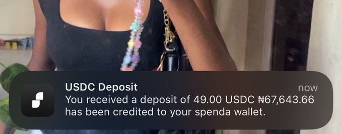 A notification from the Spenda app displays a USDC deposit of 49.00, bringing the balance to ₦67,643.66, overlaid on a photo of a woman wearing a black top and carrying a bag. The image visually complements the post's suggestion to "use Spenda today" by showcasing a real transaction notification from the platform.