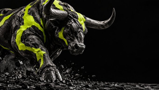 A dramatic statue of a charging bull with neon green and black coloring, appearing to break through a dark surface with debris flying.