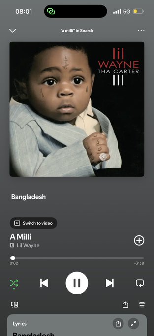 The image shows a Spotify playback screen displaying "A Milli" by Lil Wayne from the album "Tha Carter III," currently paused at 0:02 of 3:38. The post promotes celebrating $1 million by sharing videos from cars while listening to this track, with the app open and ready for users to follow along.