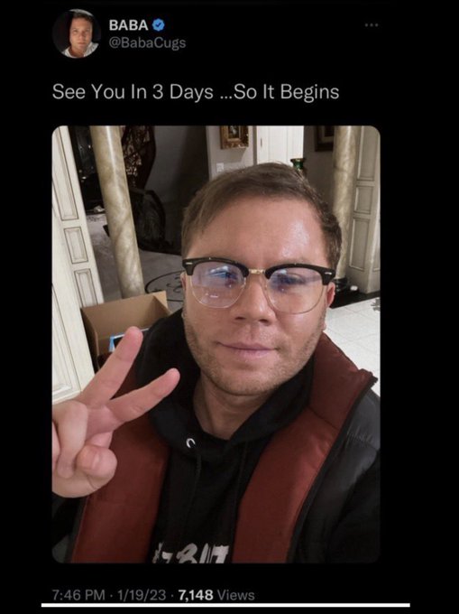 A man wearing black-framed glasses and a hoodie flashes a peace sign while sitting in what appears to be a hallway or entryway. The tweet from @BabaCugs reads "See You In 3 Days …So It Begins," posted at 7:46 PM on 1/19/23 with 7,148 views, previewing his prediction that crypto markets will surge tomorrow (1/22) and then crash Sunday into Monday, with XRP decoupling from the broader market downturn.
