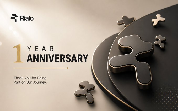 A 1 Year Anniversary graphic for 'Rialo' featuring golden puzzle pieces on a dark circular surface, with the text 'Thank You for Being Part of Our Journey.'