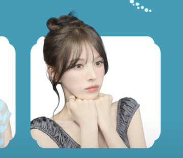 A young woman with her hair styled in a top knot poses with her hands clasped under her chin, shown within a teal-bordered photo frame as part of a "Wendy Photoism" photo card collection.
