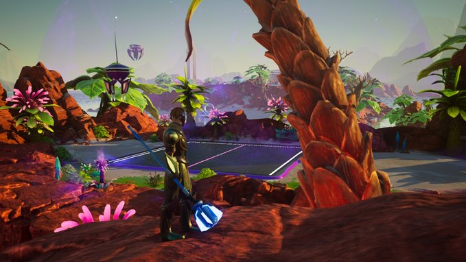 A video game scene features a character holding a large blue crystalline hammer, looking out over an alien landscape with reddish terrain, purple plants, and futuristic structures.