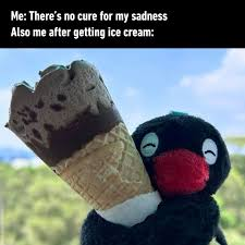 A black and red stuffed penguin is happily holding a large chocolate ice cream cone against a beach backdrop, with text reading "Me: There's no cure for my sadness / Also me after getting ice cream:" — perfectly capturing the "summer cooling" theme of the #BitFi X #ME giveaway post, which promises 200 USDT prizes to participants sharing their summer cooling plans.