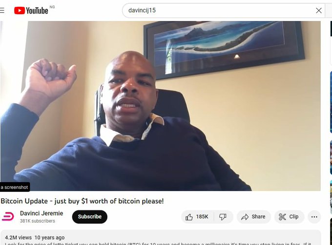 A YouTube screenshot of a man speaking, with the video title 'Bitcoin Update - just buy $1 worth of bitcoin please!' from the channel 'Davinci Jeremie'.