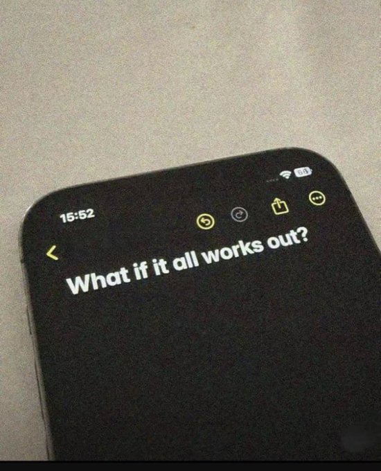 A smartphone screen displays a note reading "What if it all works out?" at 15:52, paired with the optimistic "Gm CT. We are winning this week!" message to reinforce a bullish, hopeful outlook on the markets.