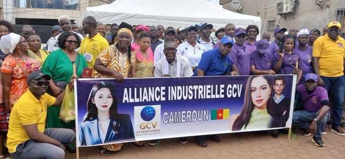 A group photo of people at an event holding a banner that reads 'ALLIANCE INDUSTRIELLE GCV CAMEROUN' featuring the GCV International logo.