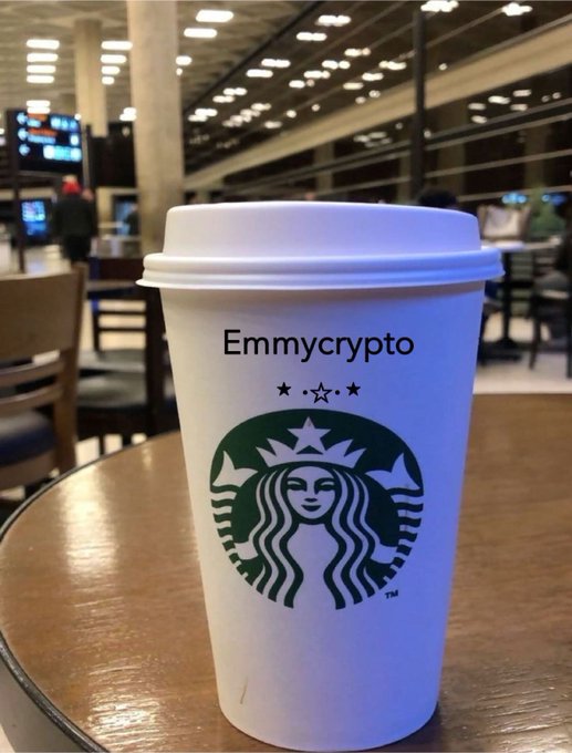 A white Starbucks cup labeled "Emmycrypto" sits on a wooden table in what appears to be an airport terminal, accompanying a late-night goodnight post likely written while traveling through Connecticut and preparing to rest before the next day.