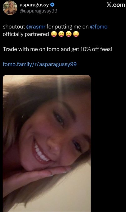 The image shows a tweet from @asparagussy99 announcing they are officially partnered with @fomo, thanking @rasmr (Rasmr) for the introduction, and offering a 10% fee discount with the link fomo.family/r/asparagussy99. Attached is a close-up selfie of a smiling young woman with blonde hair. The tweet appears to contradict the accompanying post's claim that Rasmr allegedly offers crypto partnerships in exchange for sexual services, instead presenting this as a legitimate partnership announcement.