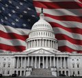 The U.S. Capitol building set against a backdrop of the American flag.