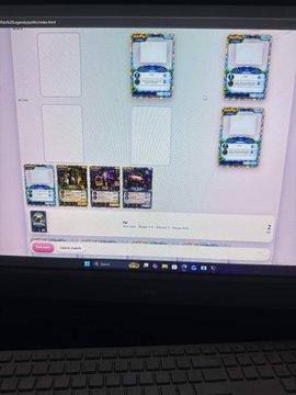A laptop screen displaying what appears to be a trading card game inventory or marketplace with several blue-bordered cards visible.