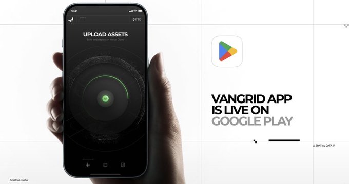 A hand holds a smartphone displaying the "UPLOAD ASSETS" screen with a green progress indicator, alongside the Google Play logo and text announcing "VANGRID APP IS LIVE ON GOOGLE PLAY." The image promotes Vangrid's app launch, showing how contributors can upload spatial data footage to fulfill capture bounties funded in USDC, as referenced in the accompanying post about real-world data collection.