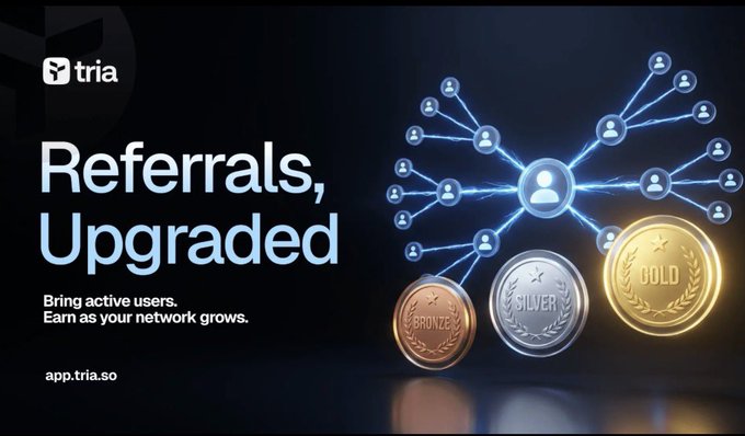 The image features a poster for Tria, which is an app that allows users to invest in cryptocurrency. The poster includes three coins with different colors - gold, silver, and bronze. These coins are used as rewards for referring other users to the app. The text on the poster reads "Referrals, Updated" and provides information about how the app works and what users can expect from it.