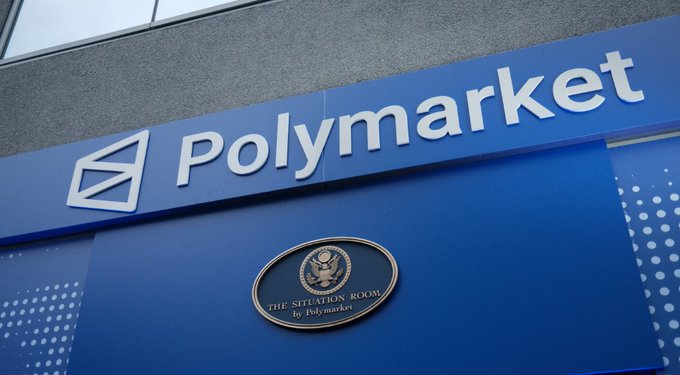 The exterior signage of the Polymarket headquarters building, displaying the Polymarket logo on a blue facade, with 'The Situation Room by Polymarket' plaque featuring the Presidential Seal below it.