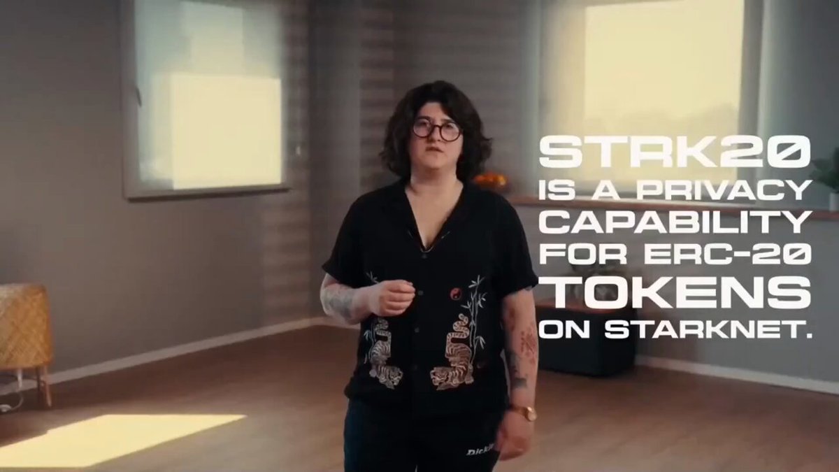 The image shows a woman standing in front of a window, wearing glasses and holding a keychain. The text above her reads "STRK20 is a privacy capability for tokens on Starknet." This suggests that the woman might be discussing or explaining the concept of tokenization and its connection to privacy within the context of the Starknet network.