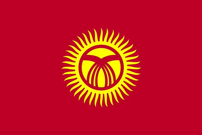 The image displays the flag of Kyrgyzstan, featuring a red background with a yellow sun emblem at its center containing a stylized depiction of the yurt roof, symbolizing the country's cultural heritage. The accompanying post highlights Kyrgyzstan's expanding role in the crypto space, with plans to pilot its digital som and enhance regulation, licensing, and stablecoin infrastructure, reflecting the nation's push toward modernizing its financial systems.